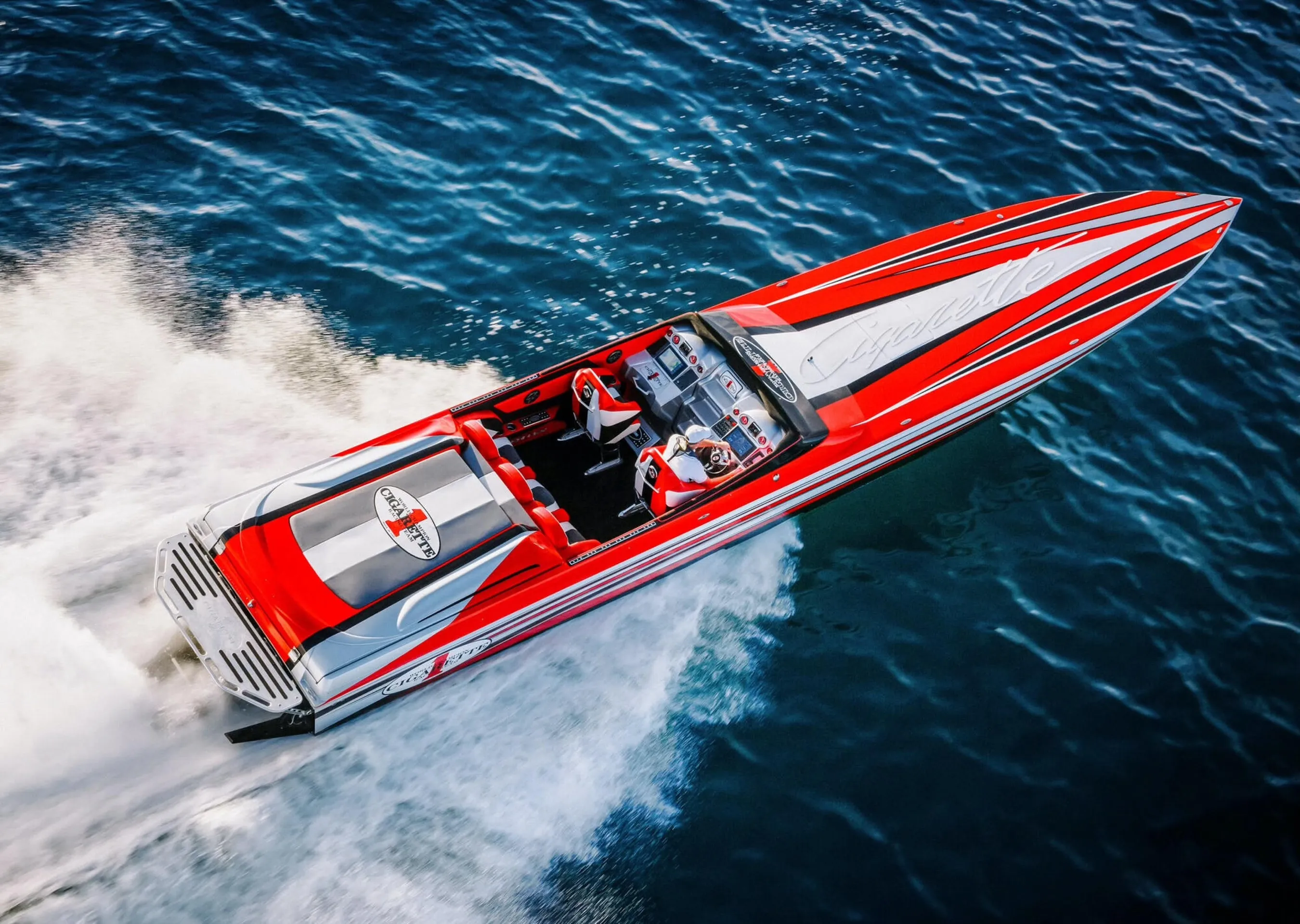 white and black boat on water during daytime — custom boat decals